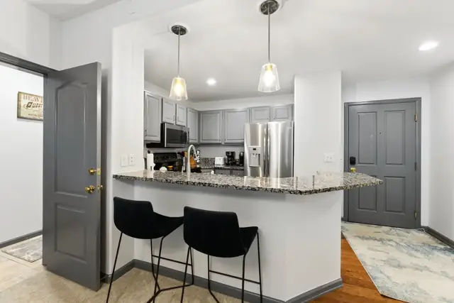 Kitchen breakfast bar with stools in the Arrowhead condo