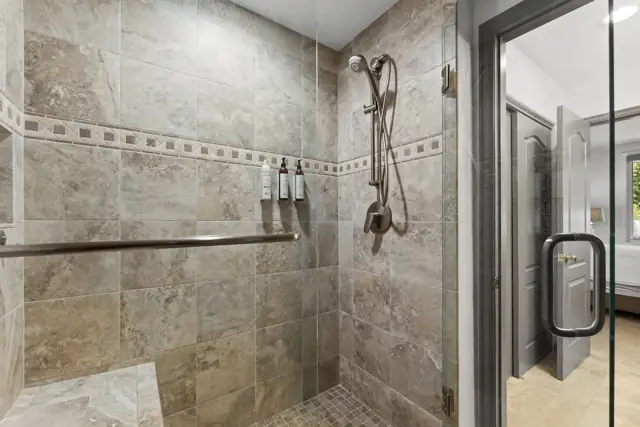 Walk-in tiled shower with bench